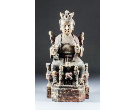 A Chinese carved and polychrome wood seated figure of Qilin Song Zi, a Fertility Deity - A female figure accompanied by nine 
