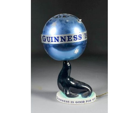 A Carlton Ware "Guinness" pottery seal pattern electric table lamp 7.5ins high, and shade for same, 15ins high overall