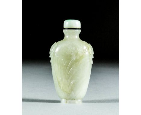 A Chinese celadon jade snuff bottle with Taotie dragon handles, carved to one side with a narcissus, the other side with bamb
