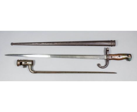 A "Brown Bess" socket bayonet, 19ins overall, indistinctly marked, and a 19th Century French St. Etienne bayonet with origina
