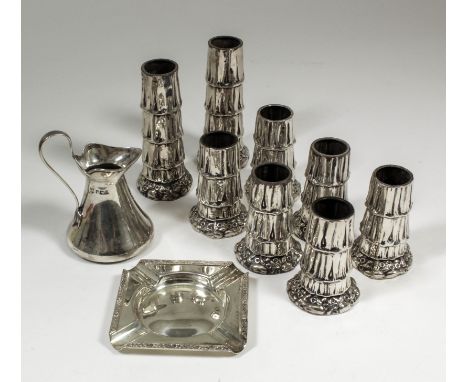 A pair of late Victorian silver tree trunk pattern spill vases of tapered form, the bases embossed with floral ornament, 4.25