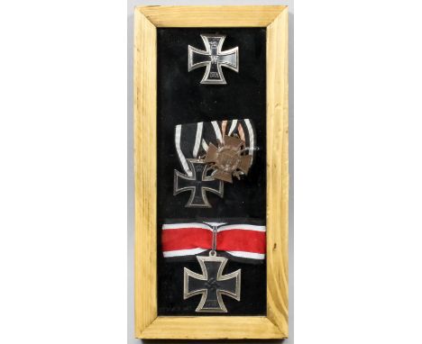 A cased small collection of German World War I and World War II Iron Cross Medals, comprising - World War I Iron Cross (First