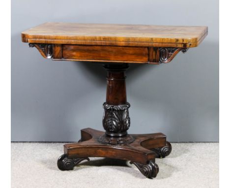 An early Victorian rosewood rectangular card table, with plain baize lined folding top, scroll carved brackets to spron, on t