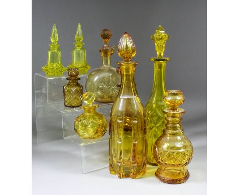 A collection of yellow glassware, including a decanter, with reeded moulded and panel cut body, form and stopper, 14ins high,