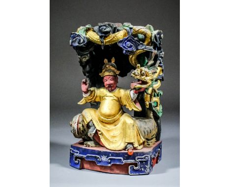 A Chinese carved polychrome and giltwood figure of Sun Zhenren -  Doctor of Internal Medicine, seated on a tiger below a cano