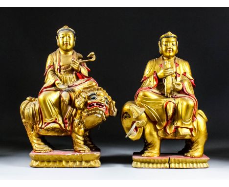 A Chinese carved red painted and giltwood figure of Wen Shu - A deity astride an elephant with a ruyi sceptre in his left han