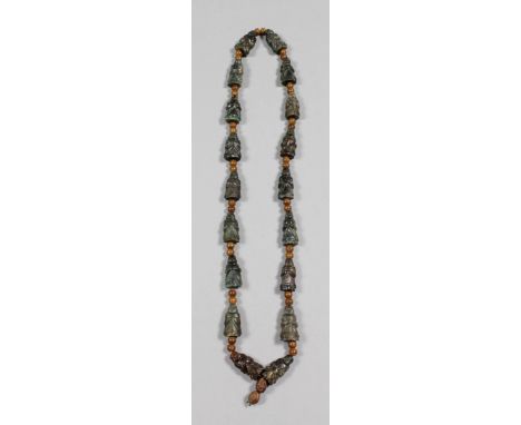 A Chinese dark green jade necklace set with eighteen carved Lohan figures, each interspersed by two wooden beads, 26ins (66cm
