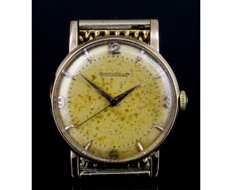 A 1950s gentleman's Jaeger Le Coultre 18k gold cased wristwatch, the circular champagne dial quarter set with Arabic numerals