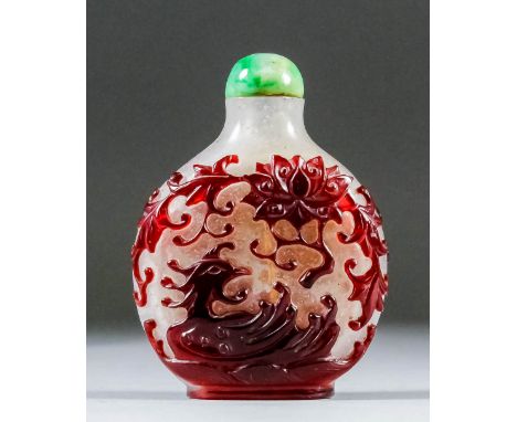 A Chinese white and ruby overlaid glass snuff bottle carved in relief with two phoenix, lotus, moon and cloud scrolls, 2.5ins