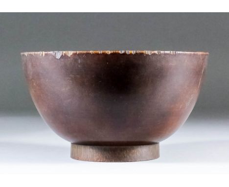 A Chinese rhinoceros horn circular bowl, 5.5ins (14cm) diameter x 3ins (7.7cm) high, (Qing Dynasty - 18th Century - some chip