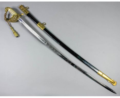 A 20th Century German Naval Officer's dress sword, the 36ins polished steel blade etched with crown over anchor, foliate work