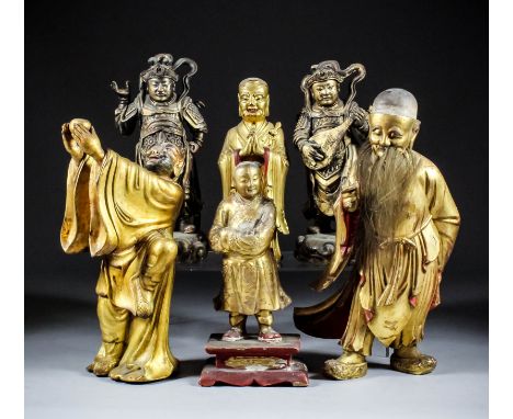 A pair of Chinese carved giltwood standing figures of Temple Guardians, each with billowing robes, one playing a mandolin and