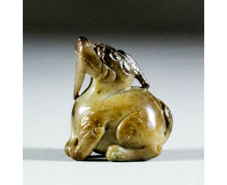 A Chinese greyish brown jade carving of a seated mythical beast, a cloud billowing from his mouth, 1.5ins (4cm) high (Ming Dy