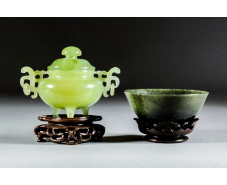 A Chinese green hardstone circular two-handled censer and cover with pierced handles and on three stump feet, 3ins (8cm) high