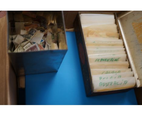 A Box containing a number of items of Philatelic Interest, to include; a tin full of packets of world stamps, a “tea caddy” c