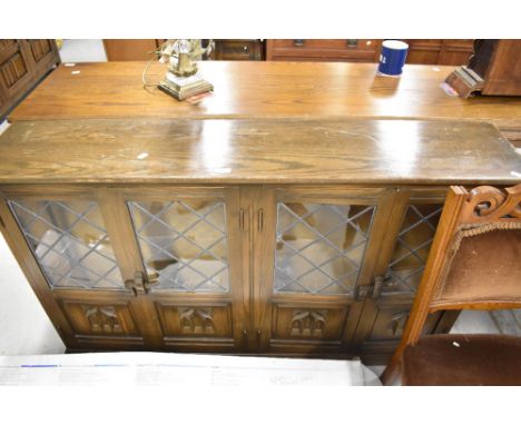 A priory style low book case with bouble cupboard space and leaded light glazed doors