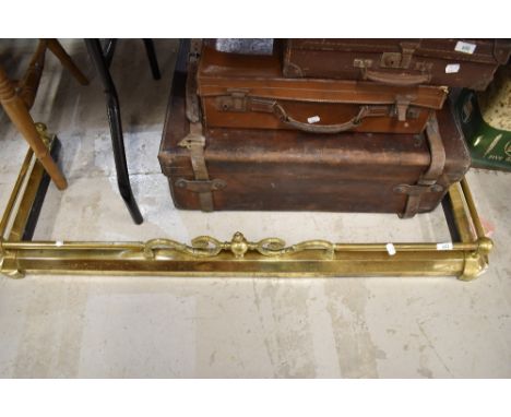 A vintage brass effect fire guard