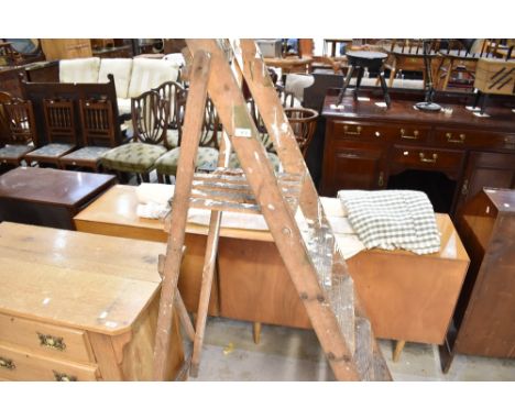 A set of vintage wooden decorators step ladders