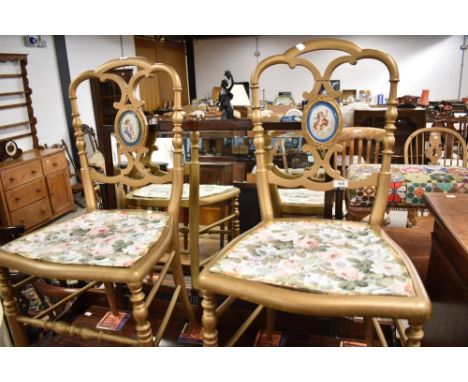 Two Victorian painted bedroom chairs having painted ceramic back panels with cherub decoration