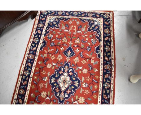 A traditional carpet runner, red ground with blue foliate pattern, approx. 304 x 77cm