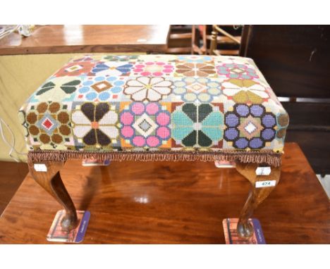 A vintage footstool having woolwork top