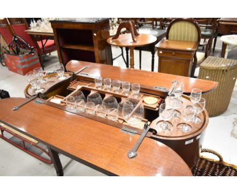 A vintage sapele fold out cocktail trolley including some contents