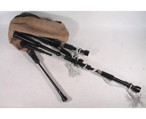 Set of modern delrin synthetic bagpipes with Bannatyne pipe bag and a practise chanter by R G Lawrie of Glasgow stamped 'Roya