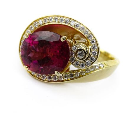 Vintage Oval Cut Rubelite Tourmaline, Diamond and 18 Karat Yellow Gold Ring. Rubelite with vivid color, measures 11mm x 9mm. 