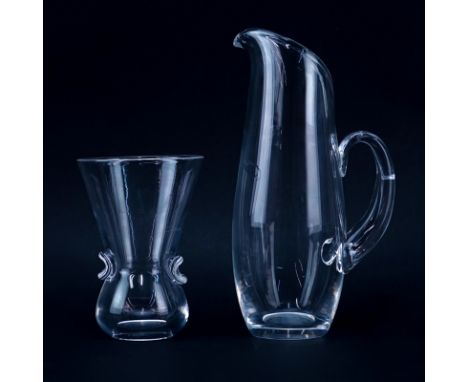 Two (2) Steuben Crystal Tableware. Includes: a carafe and vase. Each item is appropriately signed. Inclusion and possible res