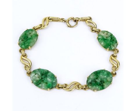 Vintage Carved Jade and 14 Karat Yellow Gold Bracelet. Stamped 14K. Very good vintage condition. Measures 7-1/2" L, 1/2" W. A