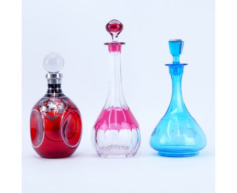 Grouping of Three (3) Vintage Decanters. Includes: a silver overlay decanter, cut to clear decanter, and floral cut decanter.