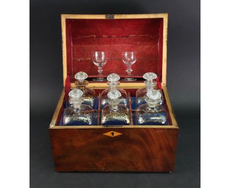 An early 19th century mahogany decanter box, rectangular with lozenge escutcheon, the curved hinged top enclosing six Venetia