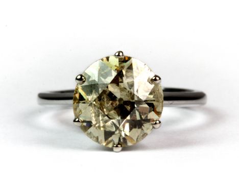 An impressive 18ct white gold solitaire ring set with a 3ct brilliant cut fancy light yellow "mystic" diamond (K).