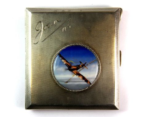 A hallmarked silver and gilt lined engine turned decorated cigarette case, with applied enamel of a Spitfire and 1945 present