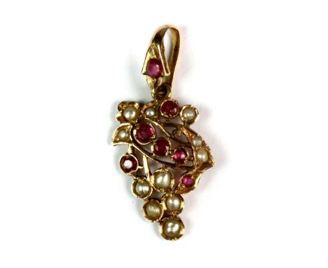 A Victorian yellow metal (tested 15ct gold) ruby and seed pearl set pendant, L. 4cm.