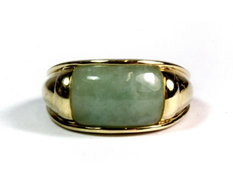 A heavy yellow metal (tested minimum 9ct gold) polished jade set ring (M).