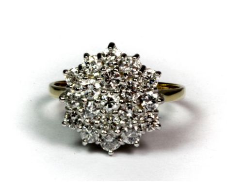 An 18ct yellow and white gold diamond set cluster ring (K.5).