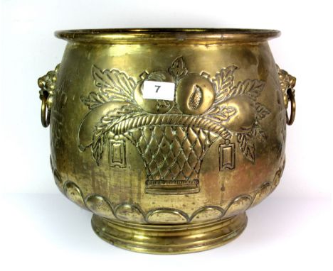 An early 20th century hammered brass planter with lion ring handles, H. 30cm, W. 42cm.