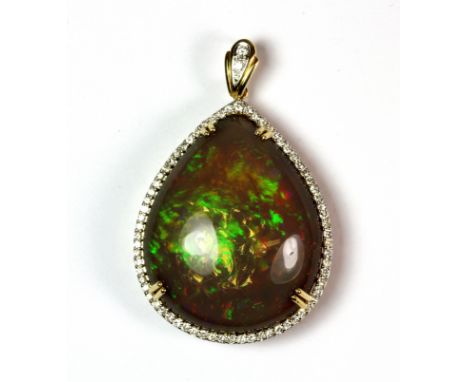 A stunning 18ct yellow gold (stamped 750) pendant set with a large pear shaped black opal (100ct) surrounded by diamonds, L. 