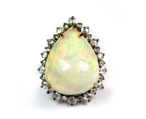 An 18ct white gold ring set with a large pear shaped opal (approx. 19.73ct) surrounded by 1.66ct of rose cut diamonds (N.5).