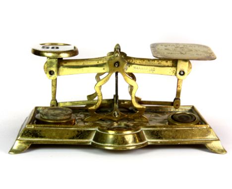 A set of 19th century brass postal scales and some weights, W. 18cm.