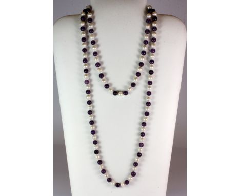 A long natural amethyst bead and cultured pearl necklace, L. 118cm.