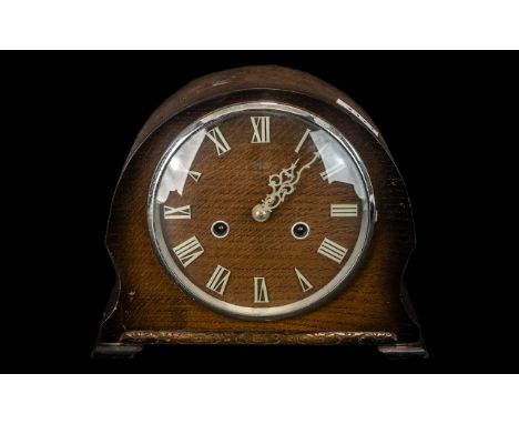 Small 1950s Oak Cased Mantle Clock with chrome numerals to the face and outer glass rim. Two hole wind.  As found.