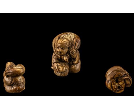 Japanese Netsuke Carved in the Form of a Man carrying a sack.  Please see images.