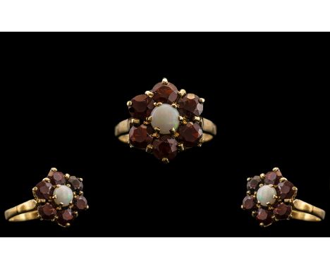 Ladies 9ct Gold Garnet and Opal Set Cluster Ring - Flower head Setting. The Central Opal Surrounded by Six Faceted Garnets. R