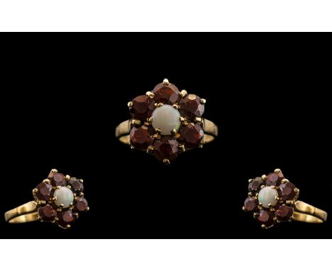 Ladies 9ct Gold Garnet and Opal Set Cluster Ring - Flower head Setting. The Central Opal Surrounded by Six Faceted Garnets. R