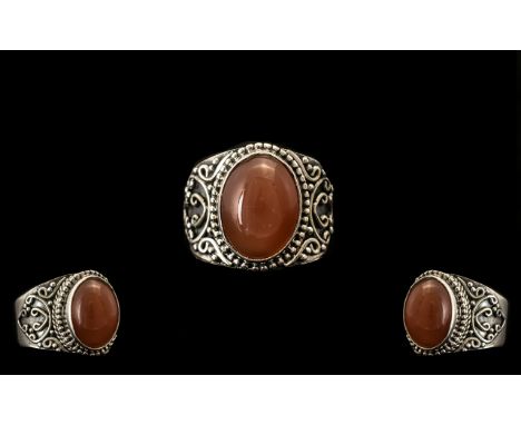 Peach Moonstone Solitaire Ring, an oval cut cabochon of 7cts, of the natural moonstone with the shadowy, ethereal, adularesce