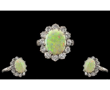 A Superb Quality 18ct White Gold - Attractive Opal and Diamond Set Dress Ring. Marked 18ct Gold. The Central Oval Shaped Opal