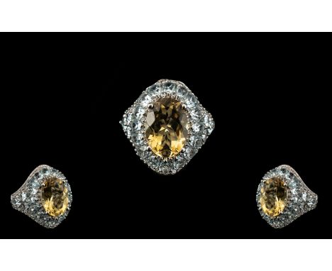 Citrine and Sky Blue Topaz Statement Ring, an oval cut, 5.25ct citrine set on a raised bank of pear cut sky blue topaz, total