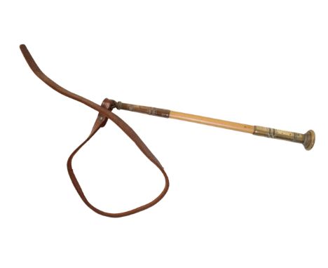AN EDWARDIAN BEAGLING WHIP with a brass top, bamboo shaft and leather thong, 27cm long